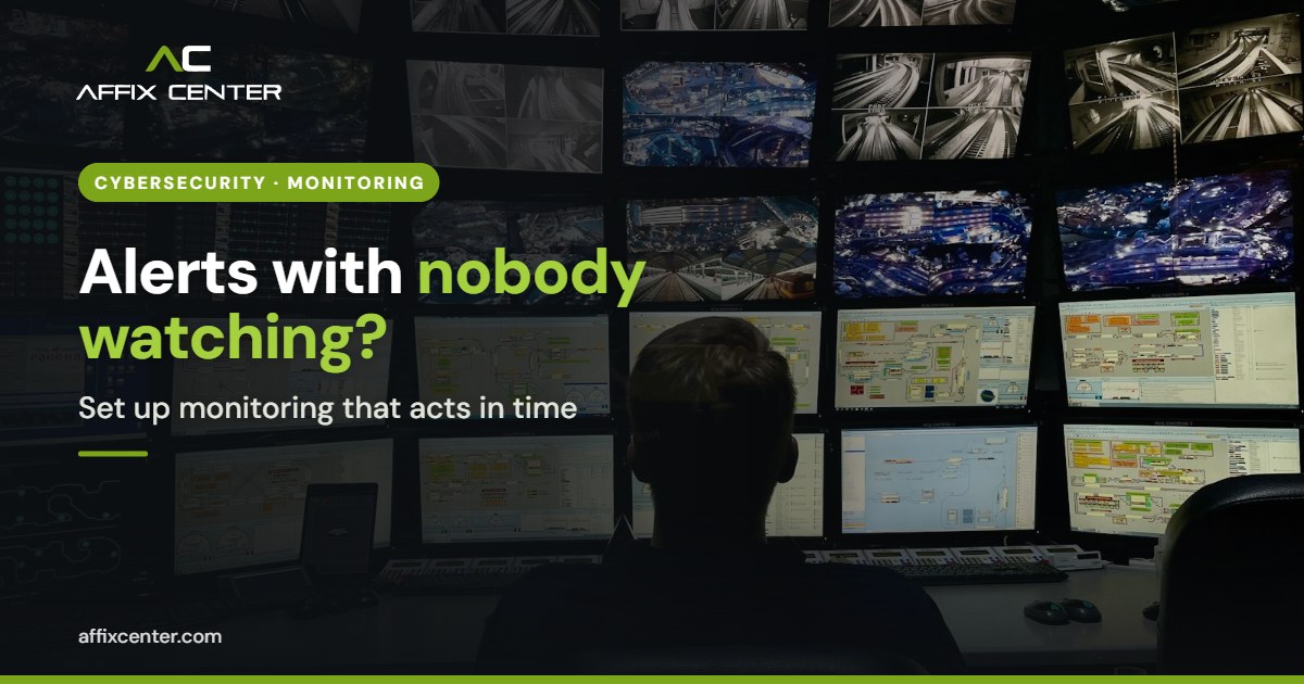 Analyst watching a wall of monitoring screens in a dark control room