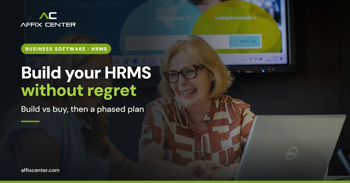 Two colleagues reviewing an HR system on a laptop in an office